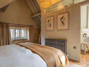 a bedroom with a large bed in a room at The Stables at Stoneythorpe in Southam