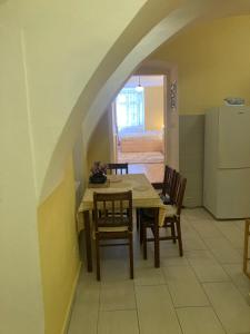 a kitchen with a table and chairs in a room at Katalin apartman in Kőszeg
