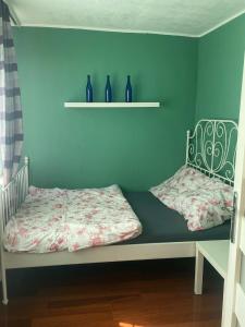 a bedroom with two beds with blue walls and vases at apartament Prokocim in Krakow