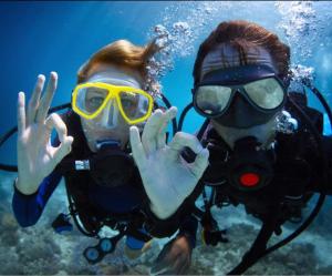 two people in diving gear posing for a picture at Tommy Tour Sahara in Dakhla