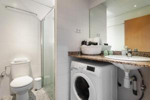 a bathroom with a washing machine and a sink at Apartments Sata Olimpic Village Area in Barcelona