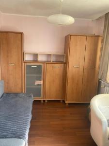a bedroom with wooden cabinets and a bed in a room at apartament Prokocim in Krakow