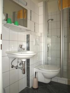 a bathroom with a sink and a toilet at Gästehaus Hubertus in Malta