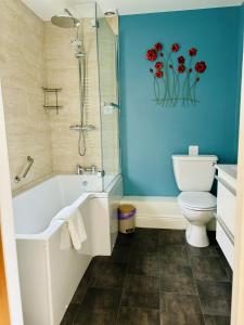 a bathroom with a white tub and a toilet at The Boatside Inn - Homers - Twin Ensuite in Hexham