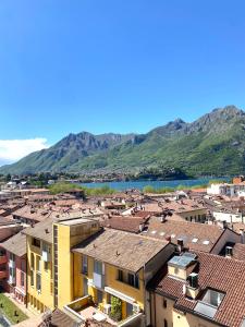 a view of a town with mountains in the background at Le Case Di Ferdinando in Lecco