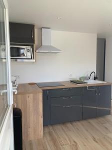 a kitchen with a sink and a counter top at Studio Calme aux terrasses de Cassis in Cassis