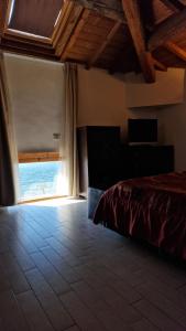 a bedroom with a bed and a large window at Cala Dei Mori in Livorno