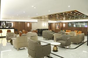 a lobby with chairs and tables in a building at Martinenz Hotel Old City in Istanbul