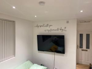 a flat screen tv hanging on a white wall at Stylish Flat - Sunderland City Centre - Sleeps up to 3 in Pallion