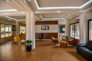 a lobby with a living room with a couch and chairs at HÔTEL MARIADOR PARK in Conakry