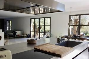a kitchen with a table in the middle of it at La Matina Family Haven with Olive Garden Oasis in Lauris
