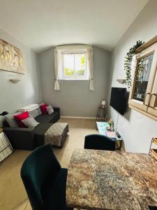 a living room with a couch and a bed at County House City Centre with parking Sleeps 4 in York