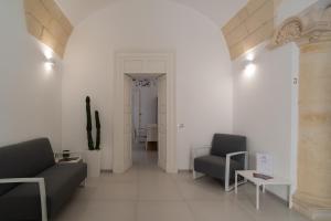 a living room with two chairs and a table at Corte dei Condò Luxury Rooms in Lecce +67 photos