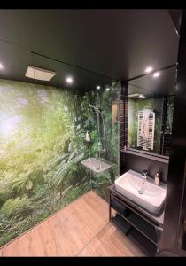 a bathroom with a shower and a sink and a mirror at Suite in Tempelhof in Berlin