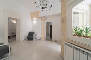 a hallway with a chandelier in a building at Corte dei Condò Luxury Rooms in Lecce