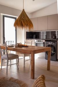 a kitchen with a wooden table and a dining room at San Francisco de Borja 2 in Gandía