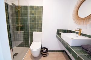 a green tiled bathroom with a toilet and a sink at San Francisco de Borja 2 in Gandía