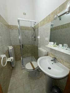 a bathroom with a toilet and a sink and a shower at PALAZZO SASSATELLI - Nel cuore di Cascia in Cascia +19 photos