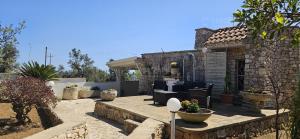 a stone house with a patio with plants at Foresta Forte Leuca by LoveSud in Leuca +21 photos
