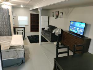 a living room with a couch and a tv at Make Yourself at Home in Austin