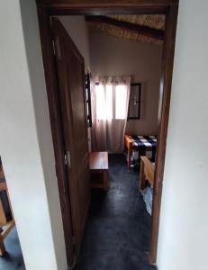 a hallway with a door leading into a room at CABAÑAS RIVIERA in Huacalera