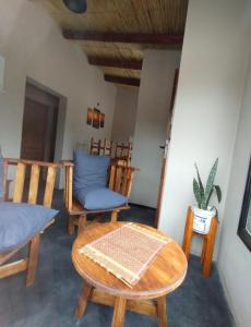 a living room with chairs and a table at CABAÑAS RIVIERA in Huacalera