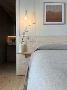 a bedroom with a bed and a picture on the wall at Salt Cliff Cottage in Doolin
