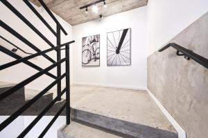 a hallway with black and white art on the wall at Hostel L44 in Nowy Targ