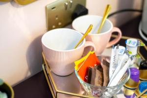 two cups on a tray with toothbrushes in them at The Galway Rooms in Galway