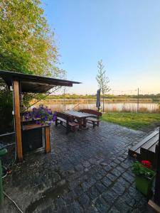 a patio with a picnic table and a bench at Boletov Raj in Čurug