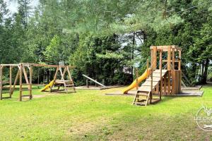 a group of playground equipment in a park at Le2085 - Spa et Plage - Les chalets dans le nord in Sainte-Lucie-de-Doncaster