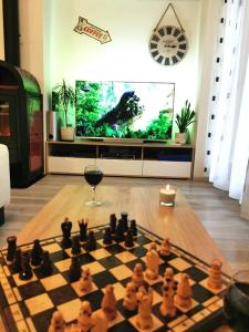 tablicę szachową i kieliszek wina w salonie w obiekcie La Harmony Jacuzzi Apartments with Garden w Splicie