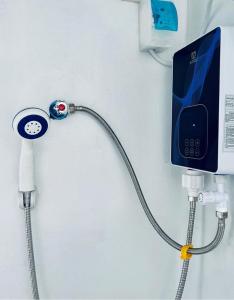 a hospital room with a iv line and a phone at Semi Studio Room at EKG House Rental in Manila
