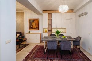 a dining room with a table and chairs at Krum khan Top Centre Apartment in Sofia