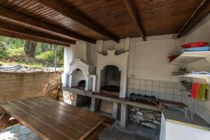 a kitchen with a wooden table and an oven at Olive Studios and Apartments in Skala Potamias