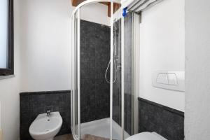 a bathroom with a shower and a toilet and a sink at Melograno Agriturismo La Ferla in Toirano +23 photos