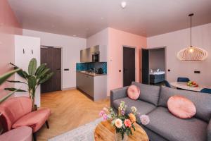 a living room with a couch and a table at Hotel Keur - Apartments in Zandvoort +91 photos