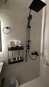 a bathroom with a shower and a shelf with toiletries at Elegant Cozy 1 BDR APARTMENT in city centre Olaya in Riyadh