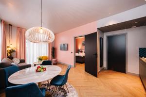 a living room with a table and a couch at Hotel Keur - Apartments in Zandvoort
