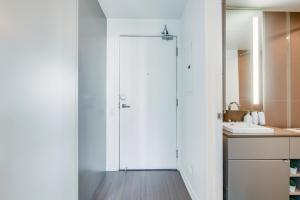 a bathroom with a white door and a sink at 1BR Condo - City View, Near CN Tower & Rogers Center in Toronto +11 photos