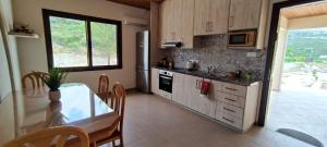 a kitchen with a table and a dining room at House on a Hill with Stunning Views near Troodos in Silikou