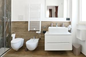 a white bathroom with a toilet and a sink at Murgia Holiday in Terlizzi +34 photos