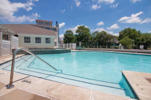 a large swimming pool with blue water at Luxury Apartment in Virginia Beach