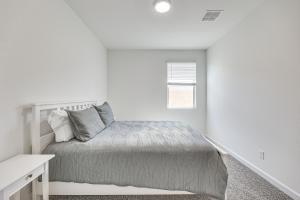a white bedroom with a bed and a window at Maricopa Home with Putting Green and Covered Patio! in Maricopa +18 photos