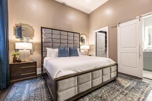 a bedroom with a large bed with blue pillows at The Livingston in New Orleans
