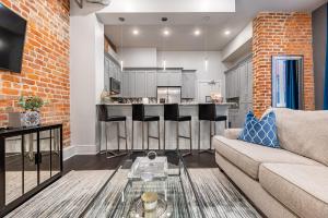 a living room with a couch and a kitchen at The Livingston in New Orleans