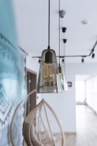 aendant light hanging from a ceiling in a room at Добрій in Svyatopetrivske