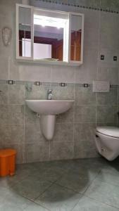 a bathroom with a sink and a toilet at Sunny House - by AP Apartment in Gallipoli