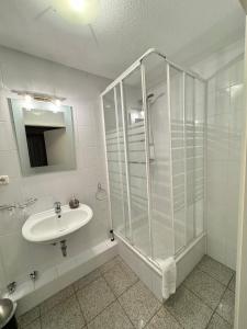 a bathroom with a shower and a sink at Hotel und Restaurant Pinkenburg in Wennigsen