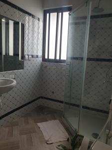 a bathroom with a shower and a sink at RAKA HOLIDAY HOMES in Malindi